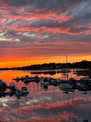 A marina with boats docked at calm waters during sunset. - Lakefront Condo (Cornelius)