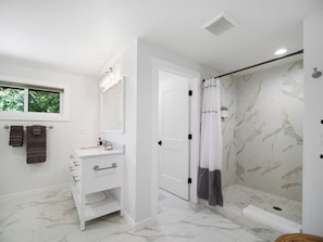 Shower, hair dryer, towels, shampoo