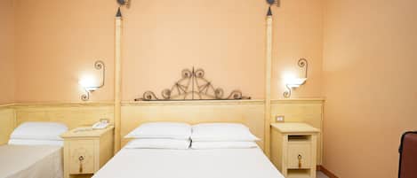 Una habitación de hotel con una cama grande, dos mesitas de noche y lámparas de pared.