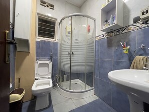 A bathroom with a toilet, shower, and sink. - Captivating 3-bed House in Kigali , Rwanda (Kigali)