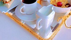 A breakfast tray with a sandwich, fruit, juice, coffee, yogurt, and cereal. - NIAMEY MALL & RESIDENCE (Niamey)