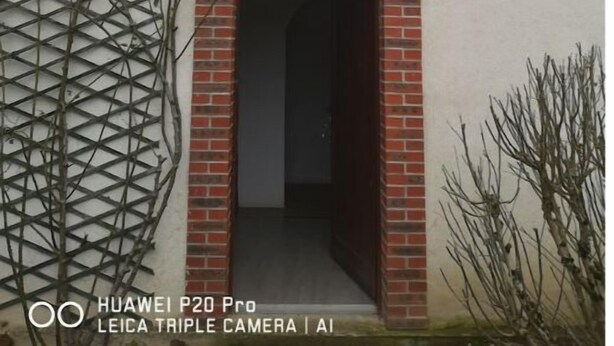 A building with a brick entrance and a white wall. - Superbe Appartement/studio (Soucy)