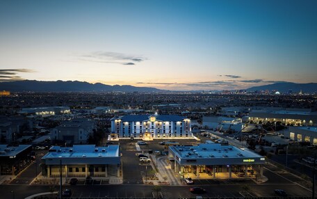 A hotel with a central courtyard, multiple floors, and a parking lot.