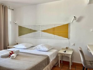 Relax in a serene space with a single bed, bedside table, and comfortable chair.