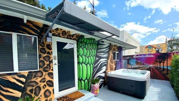 A house with a zebra-patterned exterior, a hot tub, and a door with a number 2927. - Unique Miami Art Escape w/ HotTub, Arcade & Murals (Miami)