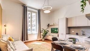 A modern apartment with a dining area, kitchen, and living room. - AwesHome Luxury Apartment (Pisa)
