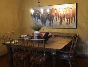 Enjoy meals in this cozy dining area with a wooden table and four comfortable chairs.