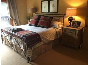 Cozy retreat with a bed, bedside tables, and ambient lighting.