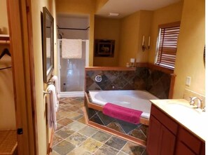 Bathroom features a bathtub, shower enclosure, and vanity with sink.