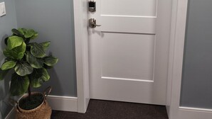 A white door with a digital lock and a label marked 'B'.