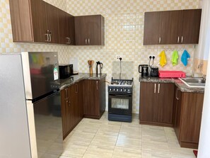 Fridge, microwave, oven, stovetop - Fully furnished 3-bedroom apartment in a serene and secure environment (Central Region)