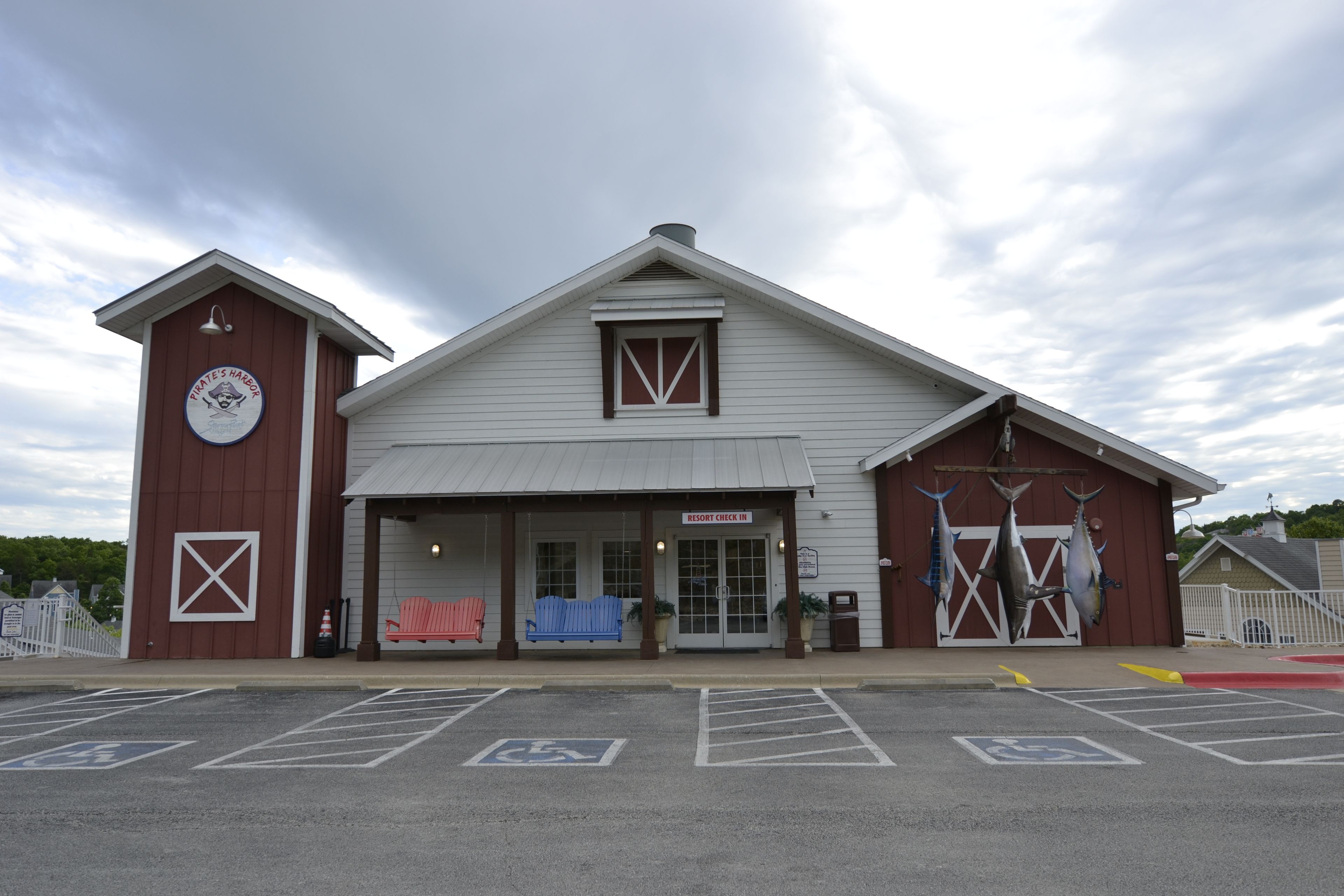 A building with a sign reading 'Resort Check In,' a large window, and a door.