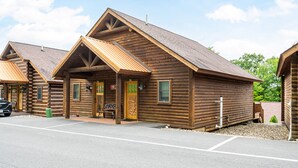 A log cabin-style building with a pitched roof and a porch.