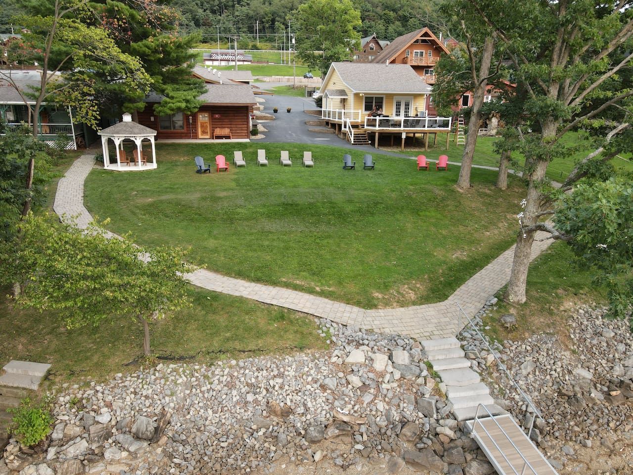 A gazebo, outdoor seating area, and a pathway leading to a building.