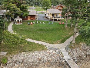 A gazebo, outdoor seating area, and a pathway leading to a building.
