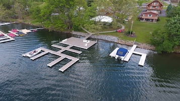 A lakeside dock with boats and a small docked boat.