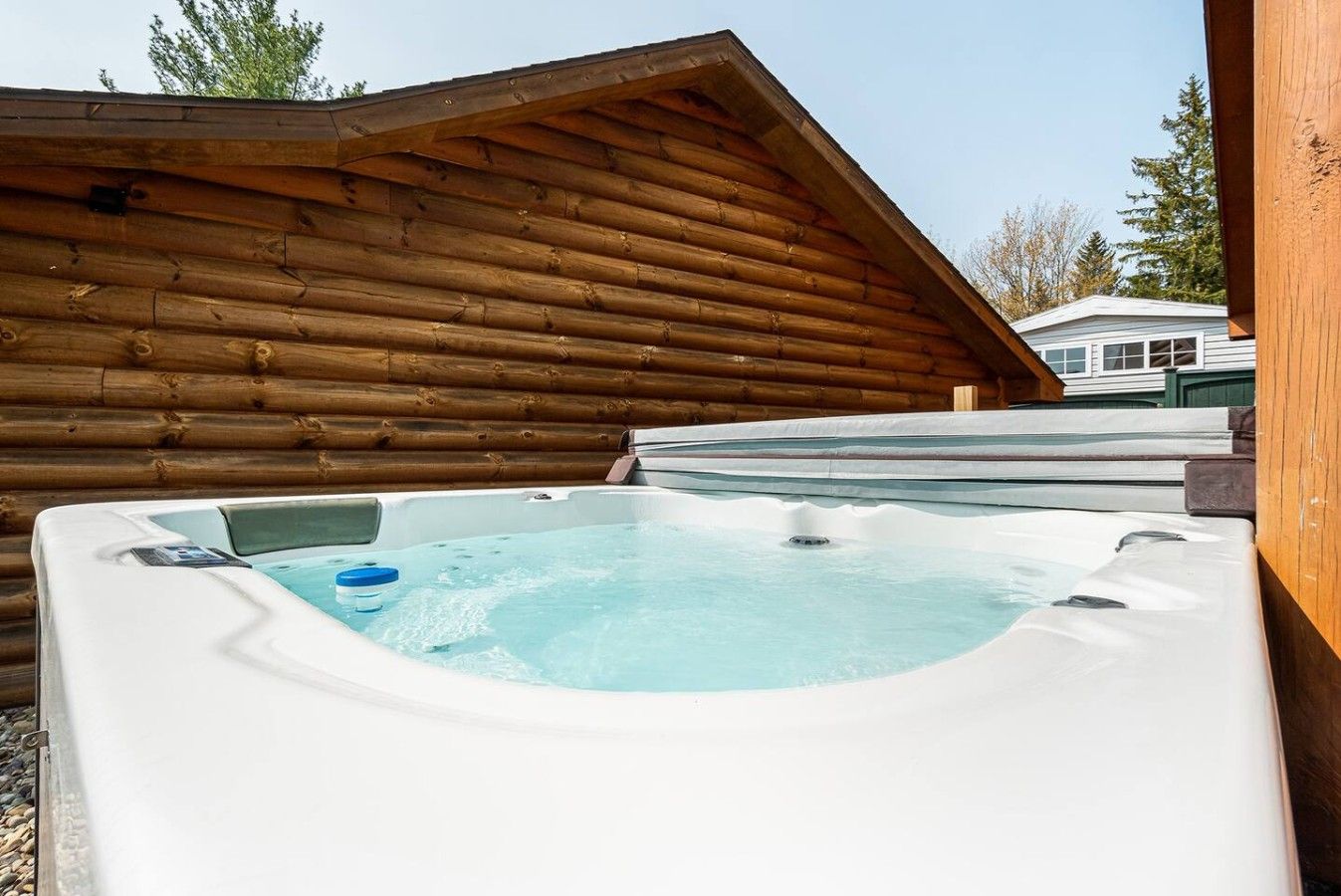 A hot tub in a wooden cabin with a clear view of the surrounding area.