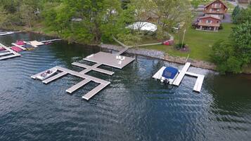 A lakeside dock with boats and a small docked boat.