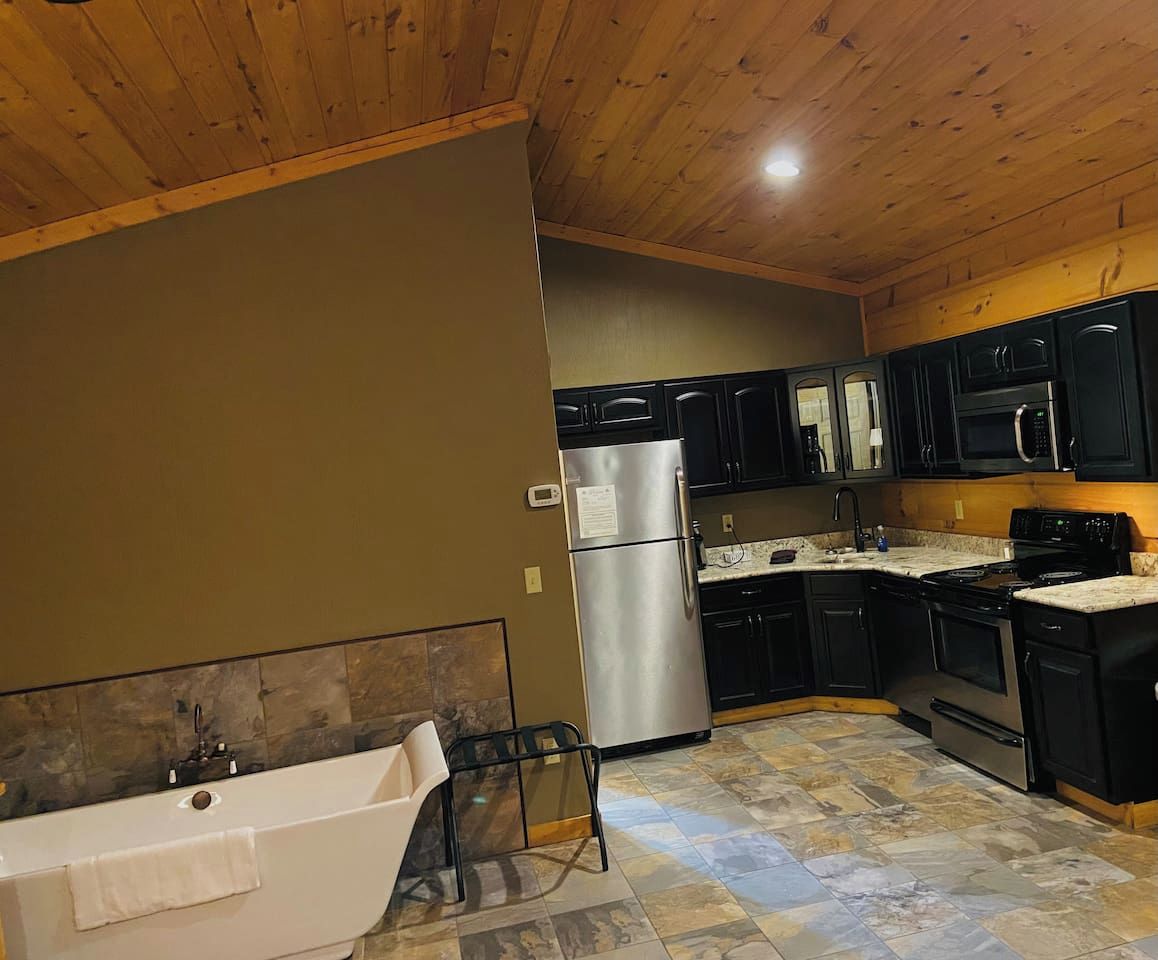 A modern kitchen with a built-in oven, microwave, and stainless steel refrigerator.