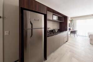 Full-size fridge, microwave, stovetop, cookware/dishes/utensils