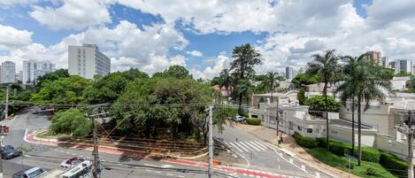 A cityscape with a curved road, buildings, and greenery.