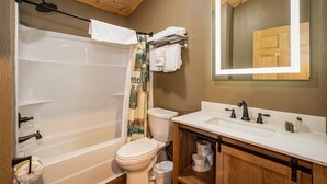 A bathroom with a bathtub, toilet, and sink. - Grandview Cabin Suite 24-Hot Tub (McHenry)