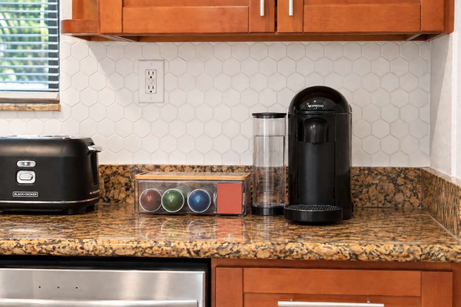 A kitchen with a toaster, a coffee maker, and a box of tea bags.