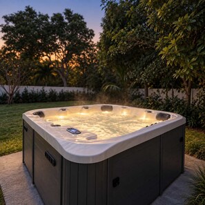 A hot tub in an outdoor setting with a control panel on the side. - Casa Palma | Pool + Hot Tub + Mini Golf (Miami)