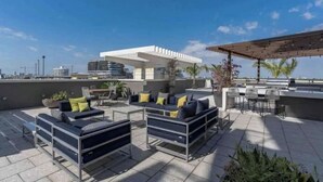 A rooftop patio with outdoor seating and a pergola. - Lovely apt in the heart Midtown (Miami)