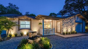 A house with a stone facade, a front porch, and a landscaped garden. - 1 Mi to Beach: Charming Largo Home w/ Private Pool (Largo)
