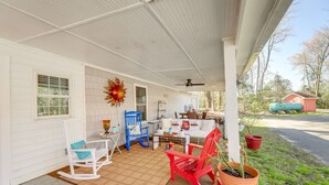 A covered porch with rocking chairs, a table, and potted plants. - Secluded Newport Getaway w/ Fire Pit & Grill! (Newport)