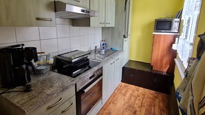 Et lille køkken med mikroovn, brødrister og kaffemaskine.
