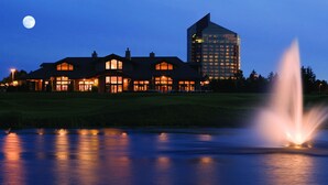 A large building with multiple windows and a fountain in front. - Brand New Beautiful 3 BDR Home Unit 838  (Traverse City)
