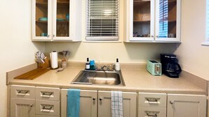 A compact kitchen with a sink, countertop, and cabinets. - NEW Listing! In the Heart of Jax Beach (Jacksonville Beach)