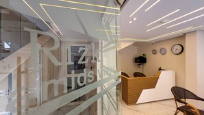A reception area with a modern design, featuring a reception desk, seating area, and a glass wall with the text "Ritzminds". - Rizk Pyramids View Hotel (Giza)
