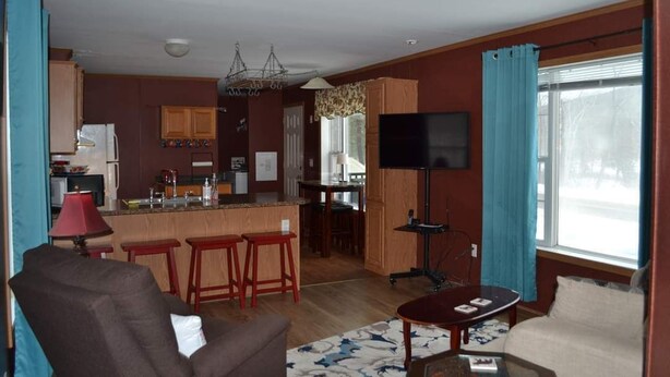 A compact living space with a kitchen, dining area, and seating area. - Cozy home in the heart of the Allagash.  Great for fishing, hiking, hunting, ect (Allagash)