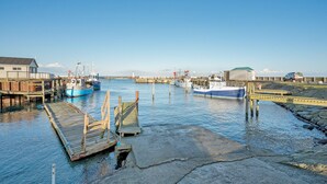 A harbor with boats docked, wooden piers, and a lighthouse in the background. - Gorgeous home in Sydals with WiFi (Sydals)