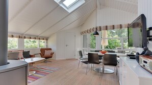 A spacious kitchen with a dining area, large windows, and a high ceiling with skylights. - Gorgeous home in Sydals with WiFi (Sydals)