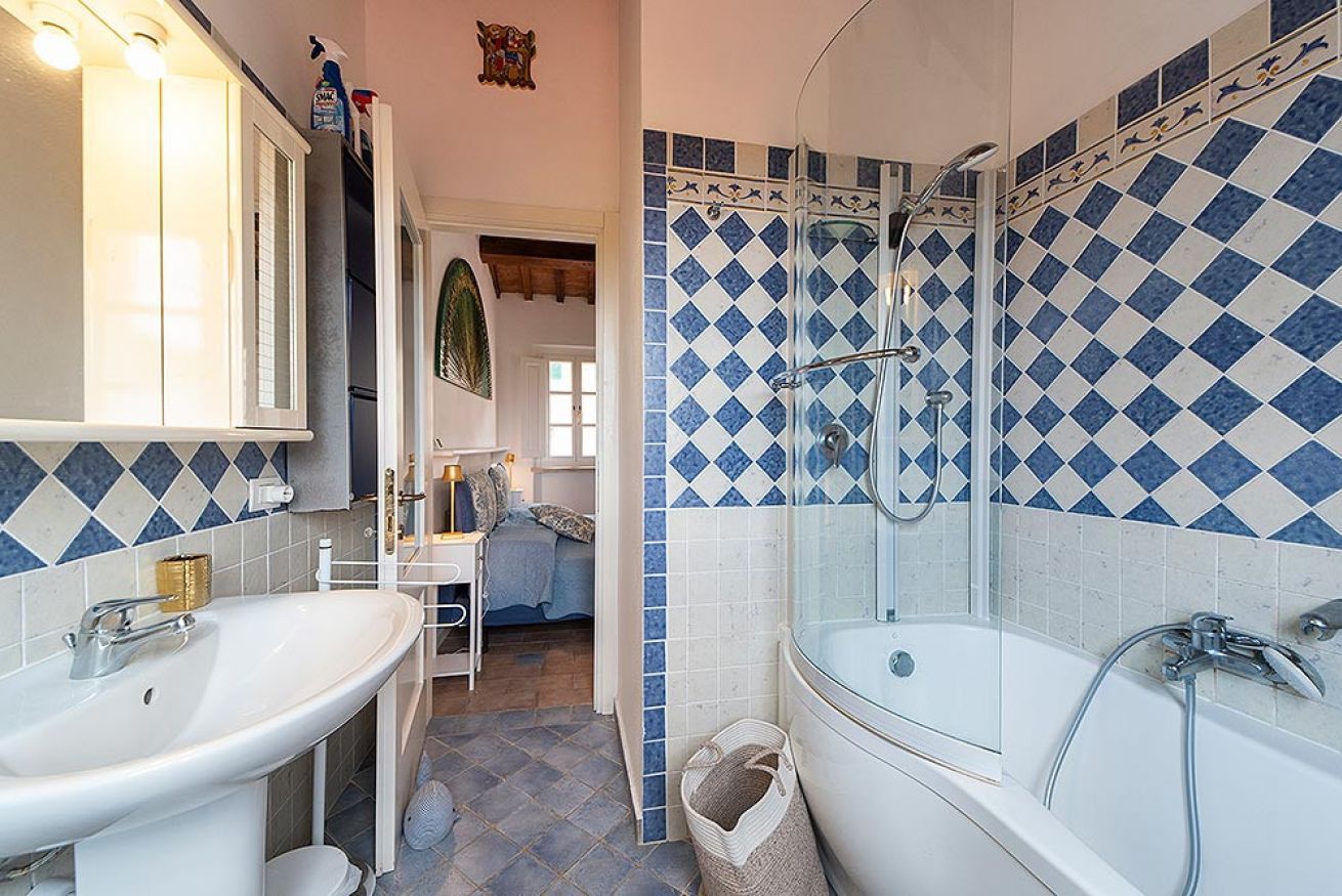 A bathroom with a bathtub, a sink, and a shower.