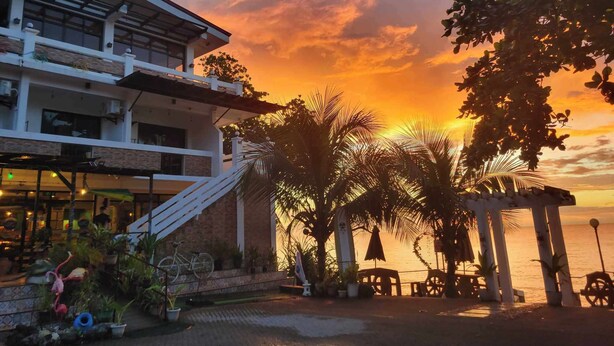 A building with a balcony overlooking a sunset view. - Costa Madrangca (San Jose de Buenavista)
