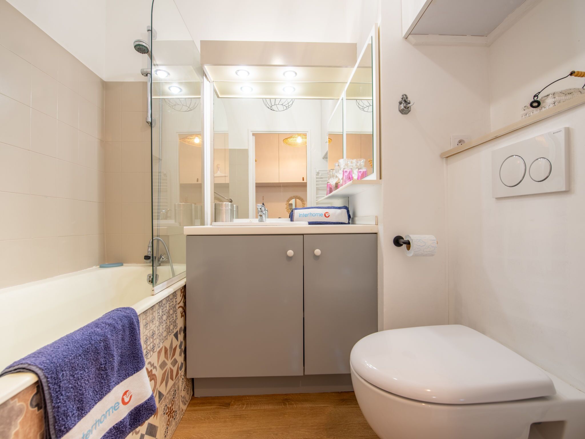 A bathroom with a bathtub, toilet, and sink.