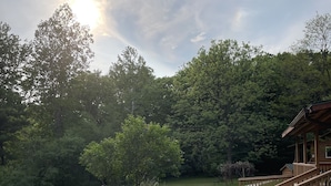 A pathway leading to a wooden house with a porch, surrounded by a well-maintained lawn and trees. - Cozy cabin in delightful Wisconsin Dells- Cabin A (Wisconsin Dells)