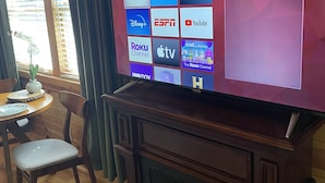 A living room with a large flat-screen TV displaying a streaming service interface. - Cozy cabin in delightful Wisconsin Dells- Cabin A (Wisconsin Dells)
