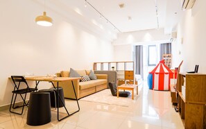 Relax in this stylish living room with a sofa, coffee table, and chair, surrounded by a decorative circus tent.