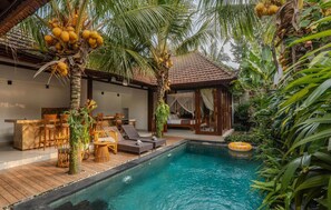 A pool area with lounge chairs, a wooden deck, and a covered seating area with a view of the pool. - The Jema Villa Ubud (Ubud)