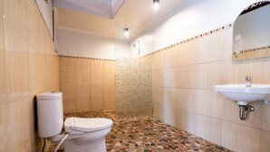 A bathroom with a toilet, sink, and tiled floor. - The Jema Villa Ubud (Ubud)