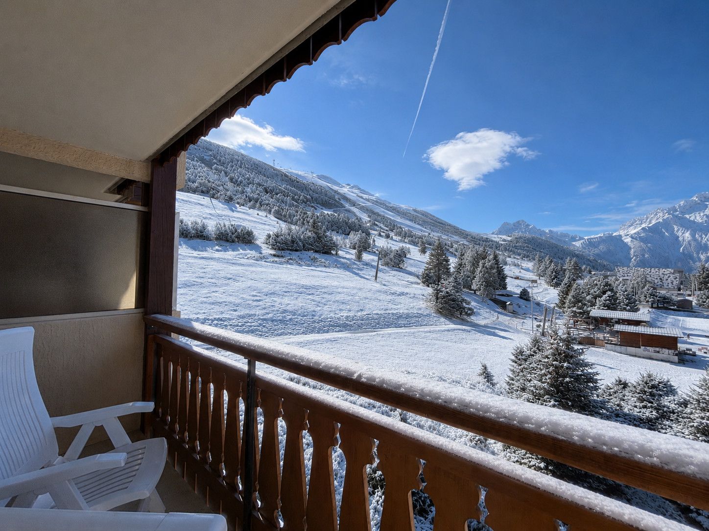 A balcony with a view of a snow-covered mountain landscape.