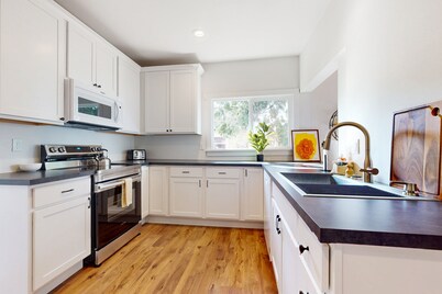 Perfectly located home with open layout, well-equipped kitchen, smart TV, & W/D