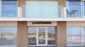 A building with a sign reading "Sunflower" above the entrance. - Apartment in Nieuwpoort near the Beach (Nieuwpoort)