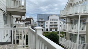 A residential building with multiple balconies and a wooden deck. - Apartment in Nieuwpoort near the Beach (Nieuwpoort)